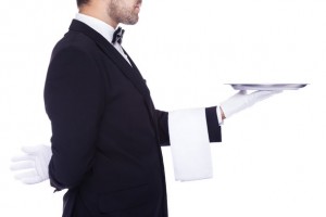 Waiter holding an empty silver tray, isolated on a white backgro