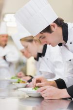 16056715 - culinary class making salads with teacher watching over