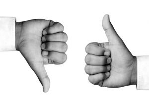 Man hand showing thumbs up and thumbs down